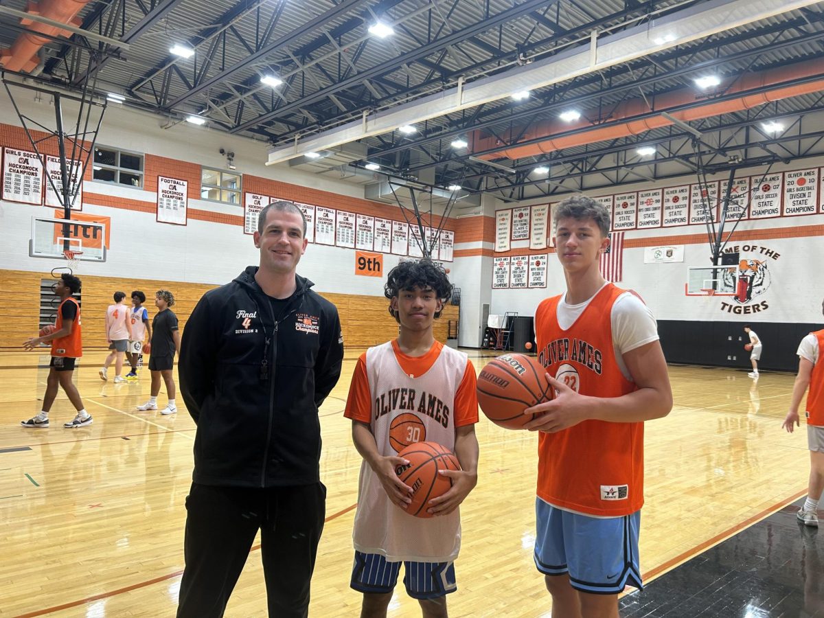 Coach MacKinnon, senior Jacob Lok, and senior Justin Grimaldi.